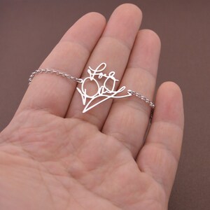 May include: A silver necklace with a delicate chain and a pendant that says "Love You Dad" in a handwritten style.