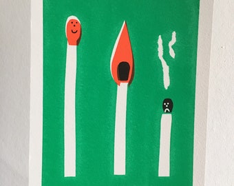 May include: A green background with three matchsticks. The matchstick on the left has a smiling face, the middle matchstick is lit with a red flame, and the matchstick on the right has a sad face and smoke coming from it. The text "MAX MACHEN 35/58" is at the bottom of the image.