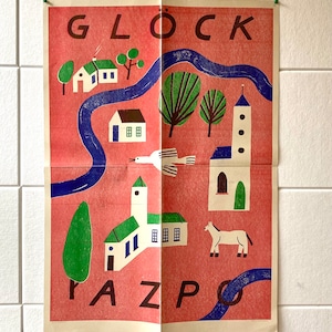 May include: A vintage poster with a red background and the words "GLOCK PAZPO" in black letters. The poster features a stylized illustration of a town with houses, a church, a river, trees, a horse, and a bird.