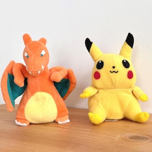 May include: A handmade wooden sign with the text "Welcome" in a handwritten style. The sign is painted white with a distressed finish and features a small, decorative heart. Measures approximately 12 inches wide.