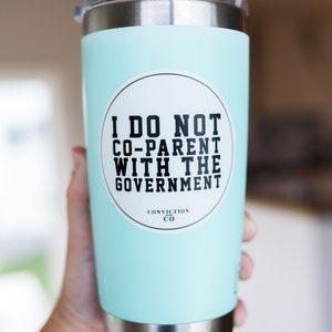 May include: A light blue stainless steel tumbler with a white sticker that says "I do not co-parent with the government" and "Conviction Co."