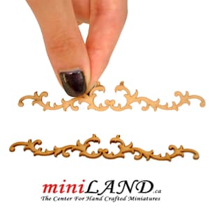May include: Two wooden decorative trim pieces with a delicate, intricate, scroll design. The trim pieces are made of unfinished wood and are perfect for adding a touch of elegance to any project.