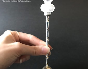 May include: Silver floor lamp with a clear glass shade. The lamp is 1:12 scale.