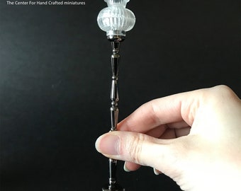 May include: A silver floor lamp with a clear glass shade. The lamp is 1:12 scale.