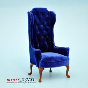 May include: A blue velvet armchair with a high back and a tufted design. The chair has wooden legs and a classic style.
