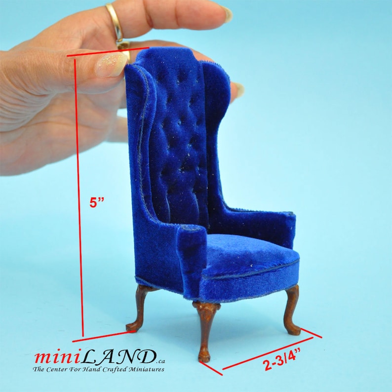 May include: A miniature blue velvet armchair with a high back and tufted upholstery. The chair is 5 inches tall and 2-3/4 inches wide.