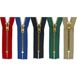 May include: Five different colored zippers with gold metal teeth and sliders. The zippers are red, blue, black, green, and beige.
