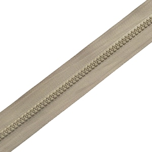 May include: A beige zipper tape featuring a continuous row of matching plastic teeth centered along the fabric strip. The design displays a uniform, neutral color palette with a textured woven fabric border and interlocking molded plastic elements.