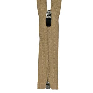 May include: A beige zipper featuring a metallic silver slider with a black pull tab. The zipper tape is a solid tan color with a textured fabric finish, and the metal teeth are closed along the length of the tape, ending in a silver stop.