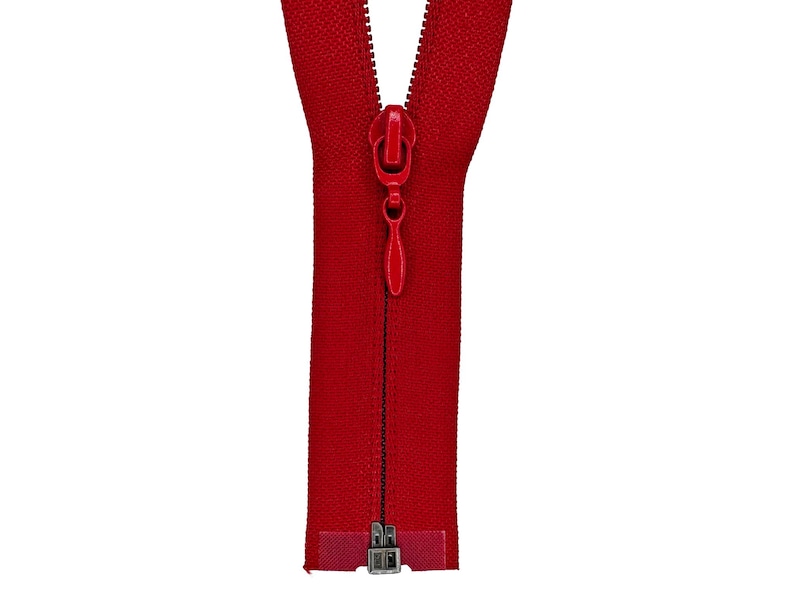 May include: A red zipper with a silver slider and a red pull tab.