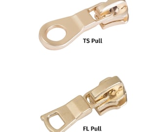 May include: Two gold-colored zipper pulls. The top pull is a  'TS Pull' with a round loop. The bottom pull is an 'FL Pull' with a rectangular loop.