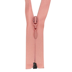 May include: A pink zipper with a black slider. The zipper is open and the slider is in the middle of the zipper.