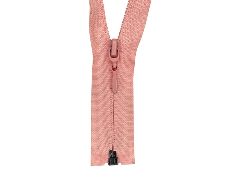 May include: A pink zipper with a black slider. The zipper is open and the slider is in the middle of the zipper.
