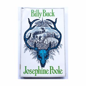 May include: A white book cover with the title "Billy Buck" in green text and the author "Josephine Poole" in green text. The cover features a blue and black illustration of a deer skull with antlers.