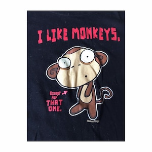 May include: Black t-shirt with a red graphic that says "I like monkeys. Except for that one."  A cartoon monkey with brown fur and big eyes is pictured below the text. The words "Roman Dirge" are printed in white at the bottom of the shirt.