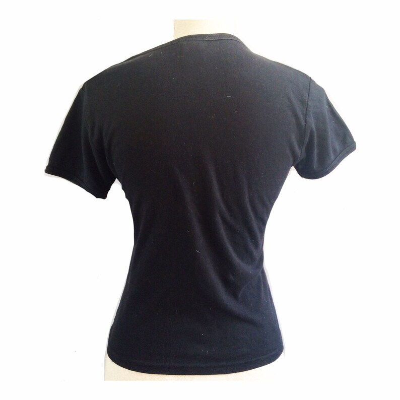 May include: A black short-sleeved t-shirt with a crew neck.