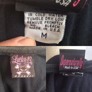 May include: Black Lucky 13 Apparel t-shirt with a skull and crossbones logo and a pink heart. The t-shirt has a care tag that reads "IN COLD WATER TUMBLE DRY LOW REMOVE PROMPTLY NO BLEACH MADE IN U.S.A." and a size tag that reads "M".
