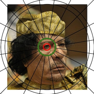 May include: A close-up portrait of a man wearing a gold patterned hat. He has dark hair and a beard. His right eye is visible and is surrounded by a green circle.