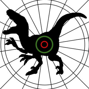 May include: A black silhouette of a dinosaur running on a white background with a green and red bullseye target in the center. The text "DARTDICKS ©" is in the upper right corner.