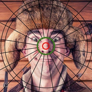 May include: A man wearing a brown fur hat with ear flaps, looking directly at the camera. His face is centered in a black and white target grid.