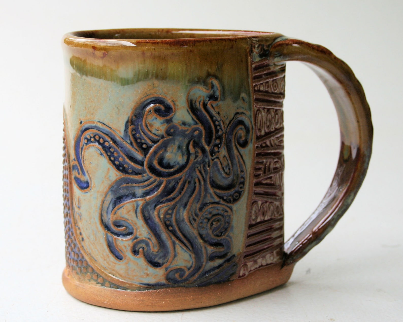 handmade painted coffee mug with an image of an octopus on it