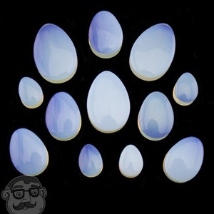 May include: A collection of 12 iridescent opalite eggs in various sizes. The eggs are a light blue color with a pearlescent finish.