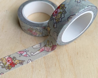 May include: Two rolls of washi tape with a floral and geometric design. The tape is light green with pink flowers and white geometric shapes.
