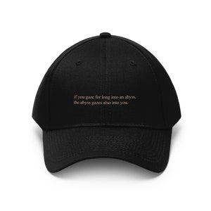 embroidered nietzsche quote hat gaze long into abyss
