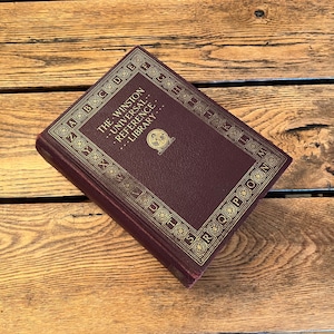 May include: A burgundy book with gold lettering and a decorative border. The title is "The Winston Universal Reference Library".