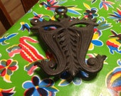 Vintage Doodlers Dream heavy black cast iron Mardi Gras mask trivet