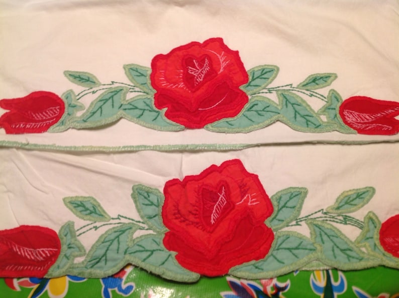Vintage pair of embroidered pillowcases with rose designs