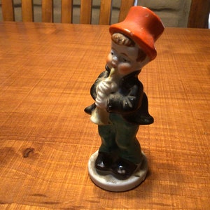 Vintage ceramic hand painted figurine of boy in top hat playing a horn  - Japan