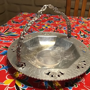 Vintage hand forged aluminum bowl with handle and chrysanthemum design