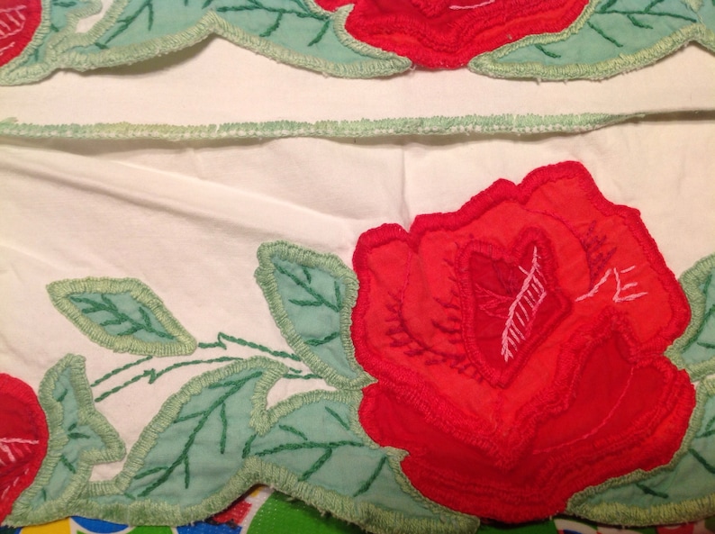 Vintage pair of embroidered pillowcases with rose designs