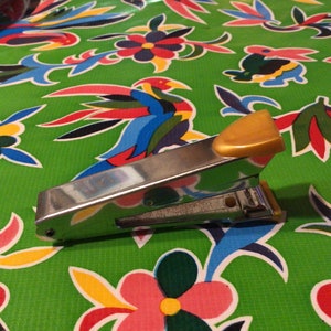Vintage mid century stainless steel Regal Model 25 compact metal office stapler with yellow plastic or Bakelite grips.