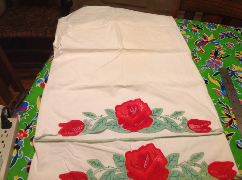 Vintage pair of embroidered pillowcases with rose designs