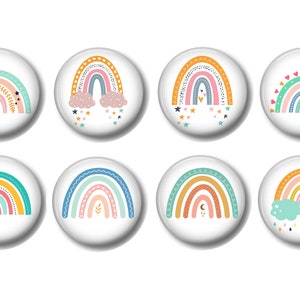May include: Eight colorful rainbow designs on white round buttons. Each rainbow has a different pattern and design, including stars, hearts, clouds, and leaves.