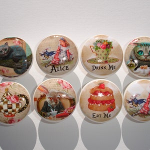 May include: Nine round ceramic knobs with colorful Alice in Wonderland themed designs. The designs include Alice, the Cheshire Cat, the Mad Hatter, the Queen of Hearts, and the words "Drink Me", "Eat Me", and "Alice".