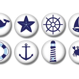 May include: Eight blue and white nautical themed buttons with various images including a whale, starfish, ship's wheel, sailboat, life preserver, anchor, lighthouse, and crab.