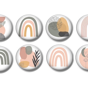 May include: Set of eight round, white, glossy magnets with abstract designs in pink, gray, and yellow. The designs include rainbows, geometric shapes, and floral elements.