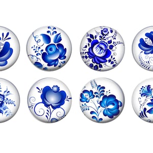 May include: Eight round, white ceramic cabochons with blue and white floral designs. The designs are reminiscent of traditional Russian folk art.