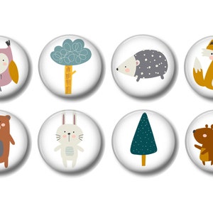 May include: Set of eight round white buttons with colorful illustrations of woodland animals and trees. The animals include an owl, a hedgehog, a fox, a bear, a rabbit, and a squirrel. The trees include a green tree and a blue pine tree.