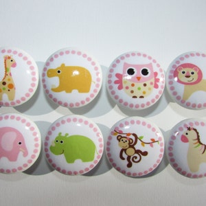 May include: Set of eight pink and white ceramic knobs with various animal designs, including a giraffe, hippopotamus, owl, lion, elephant, monkey, and zebra.