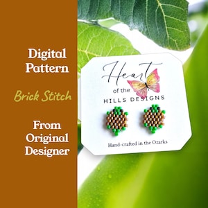 May include: A pair of handmade beaded earrings in a brick stitch pattern. The earrings are green, brown, and gold. The earrings are displayed on a white card with the text "Heart of the Hills Designs" and "Hand-crafted in the Ozarks."
