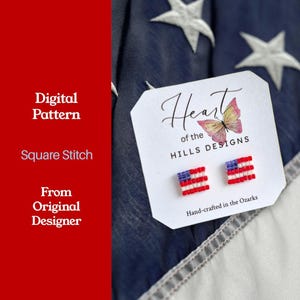 May include: A pair of beaded flag earrings on a white tag with the text "Heart of the Hills Designs". The earrings are red, white, and blue, resembling the American flag. The tag also includes the text "Hand-crafted in the Ozarks".