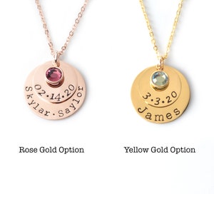 May include: Two gold necklaces with layered discs. The top disc has a small gemstone, and the bottom disc has engraved text. The left necklace is rose gold with a pink gemstone and the text "Skylar 02.14.20 Saylor". The right necklace is yellow gold with a blue gemstone and the text "James 3.3.20".