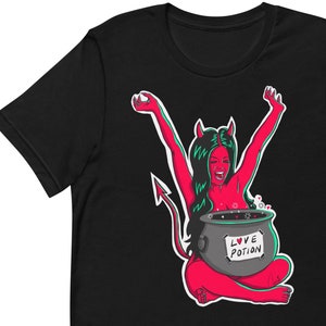 Op de afbeelding: Een zwart T-shirt met een rood duivels karakter in een ketel met de tekst "Love Potion".