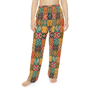 May include: Full-length pants featuring a patchwork design of various rectangular segments. Each segment displays a distinct ikat-style diamond pattern in vibrant shades of teal, mustard yellow, deep red, and dark blue, with an elasticized waistband.