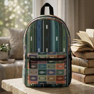May include: A backpack featuring a vertical striped pattern in shades of green, blue, and black with white geometric accents. The front pocket displays a grid of rectangular stamps, each containing a different fish illustration in various colors.