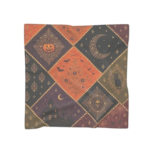May include: A square scarf featuring a diamond-patterned patchwork design in shades of orange, purple, and black. The print includes illustrations of a jack-o'-lantern, a crescent moon, a black cat, a skull, a haunted house, bats, and spiderwebs.